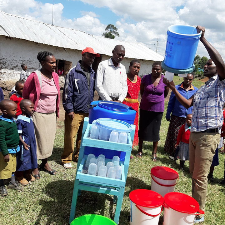 School staff and pupils are trained on how to use the School Water Filter by Aqua Clara employee, Douglas